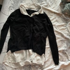 White collared shirt with black sweater